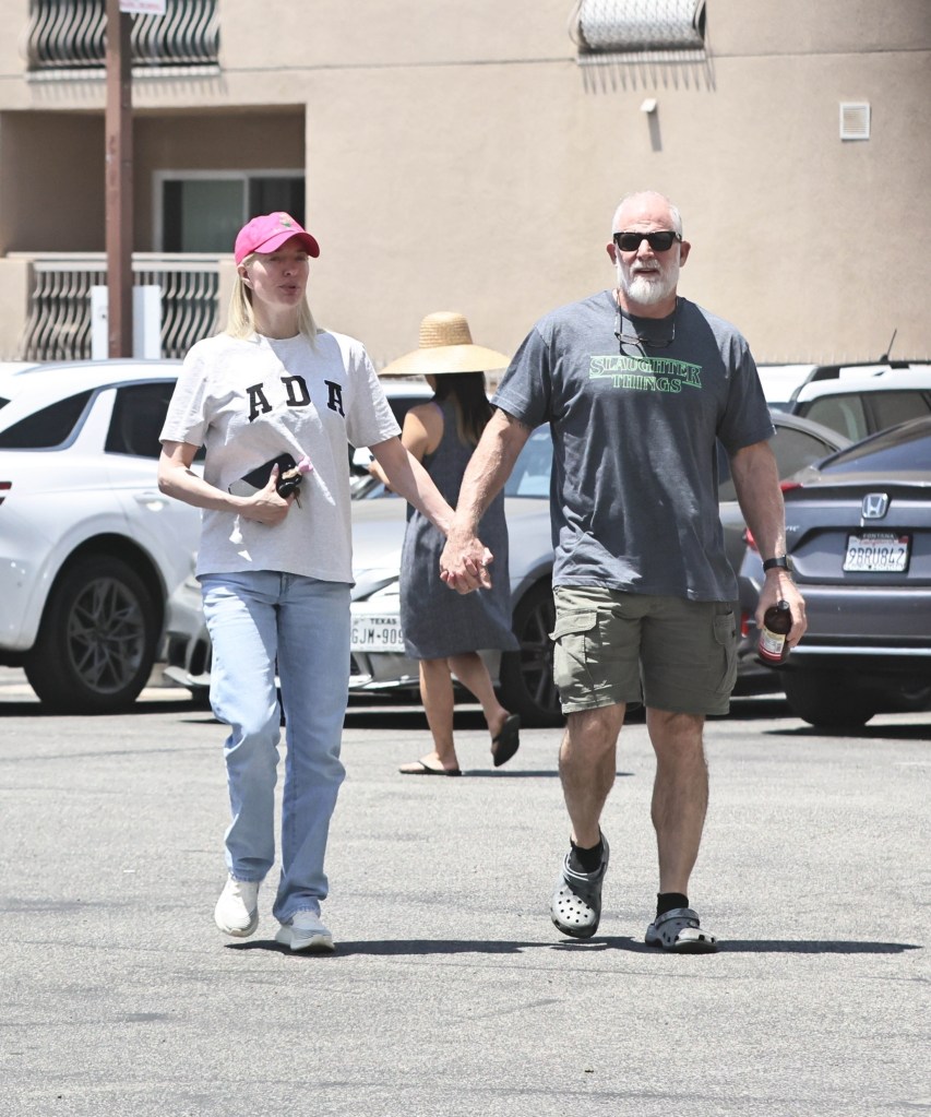 Erika Jayne holding hands with army vet John McPhee.
