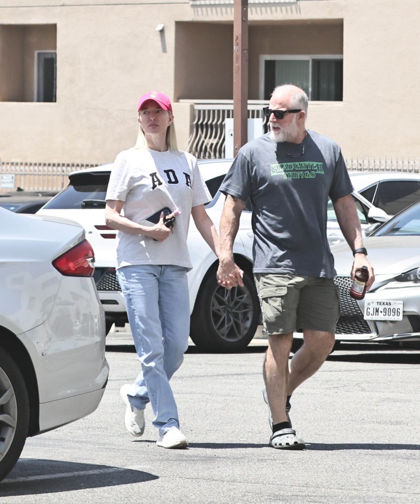 Erika Jayne holding hands with army vet John McPhee.
