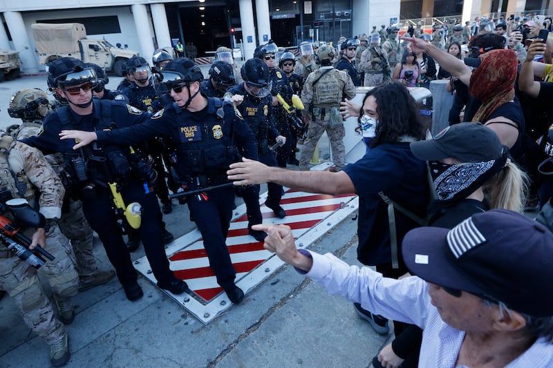 Los Angeles, CA - July 04: US Customs and Border Protection officers and DHS police push back Angelenos as they rally against the ongoing ICE raids taking place in the city in front of the Edward R. Roybal Federal Building on Friday, July 4, 2025 in Los Angeles, CA. (Carlin Stiehl / Los Angeles Times via Getty Images)
