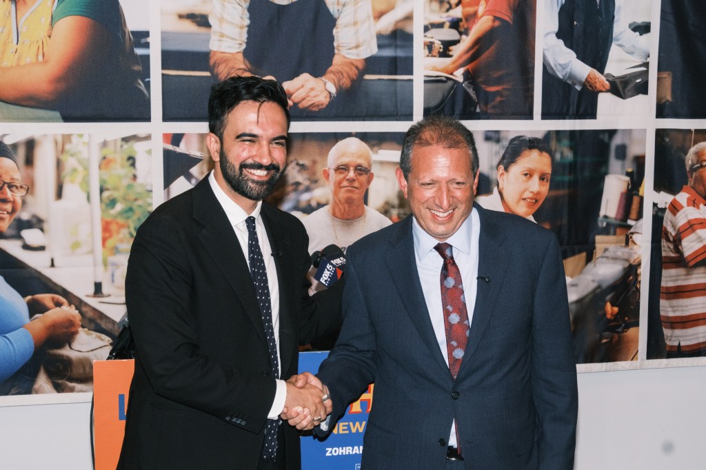 Zohran Mamdani and Brad Lander shaking hands.