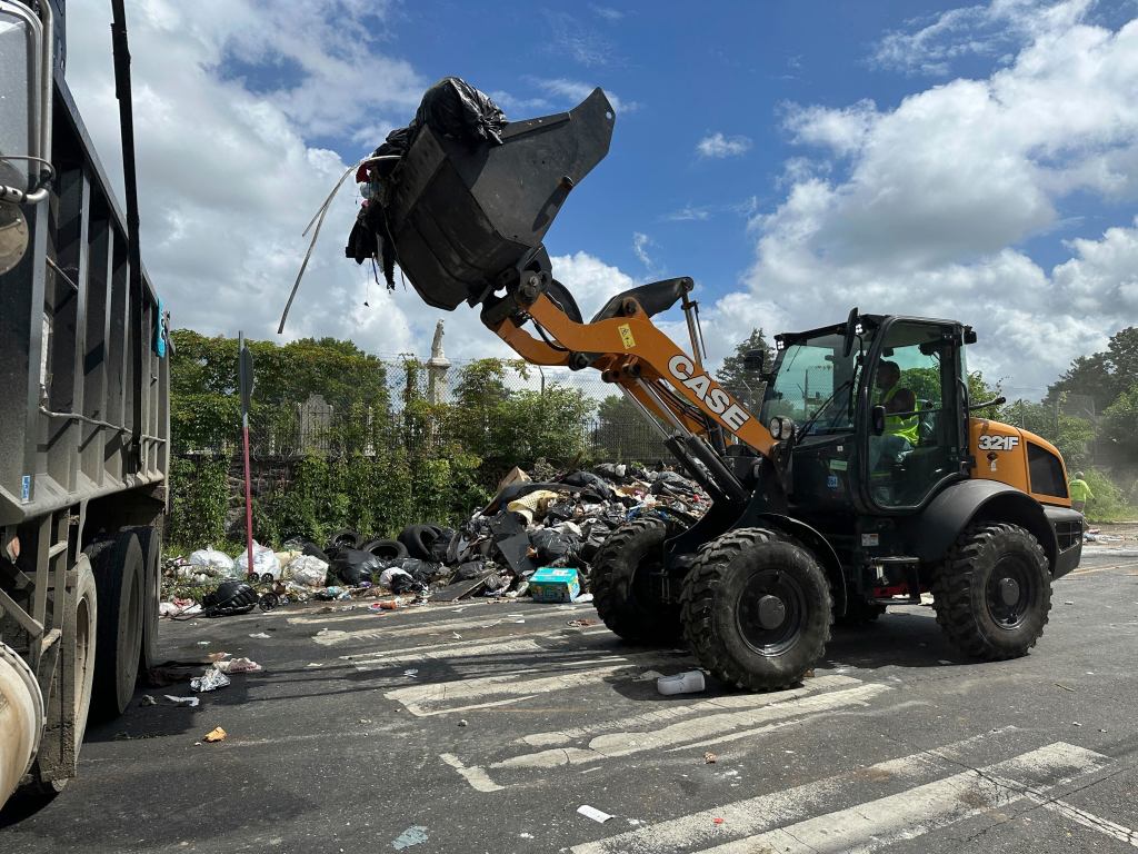 A front end loader was brought in to clean up the collection sites overflowing with garbage in Philadelphia on July 7, 2025.