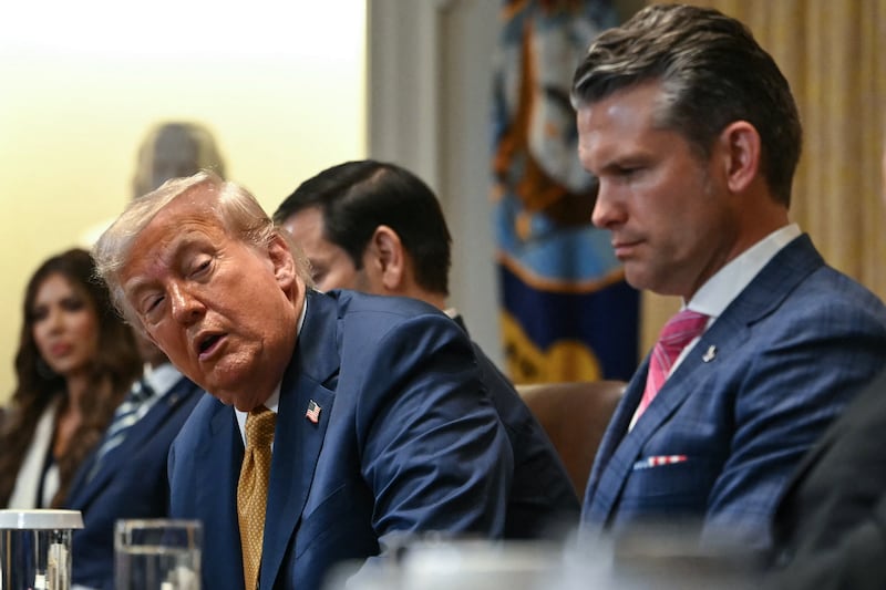 Donald Trump speaks alongside Secretary of Defense Pete Hegseth and Secretary of Commerce Howard Lutnick during a cabinet meeting in the Cabinet Room of the White House in Washington, DC,