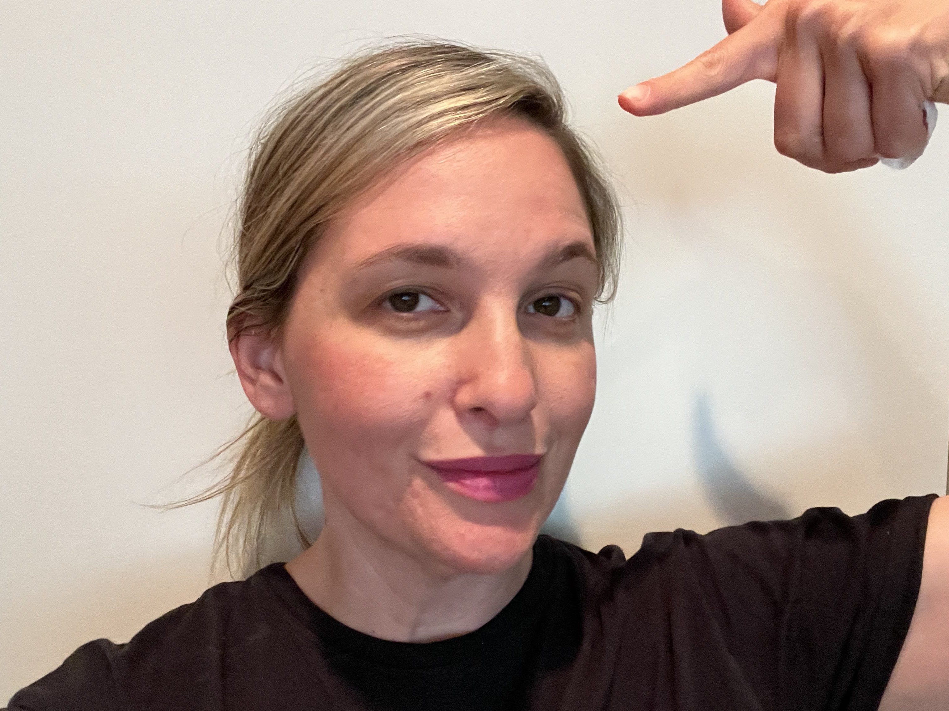 Author taking selfie at the end of the day and pointing to herself.
