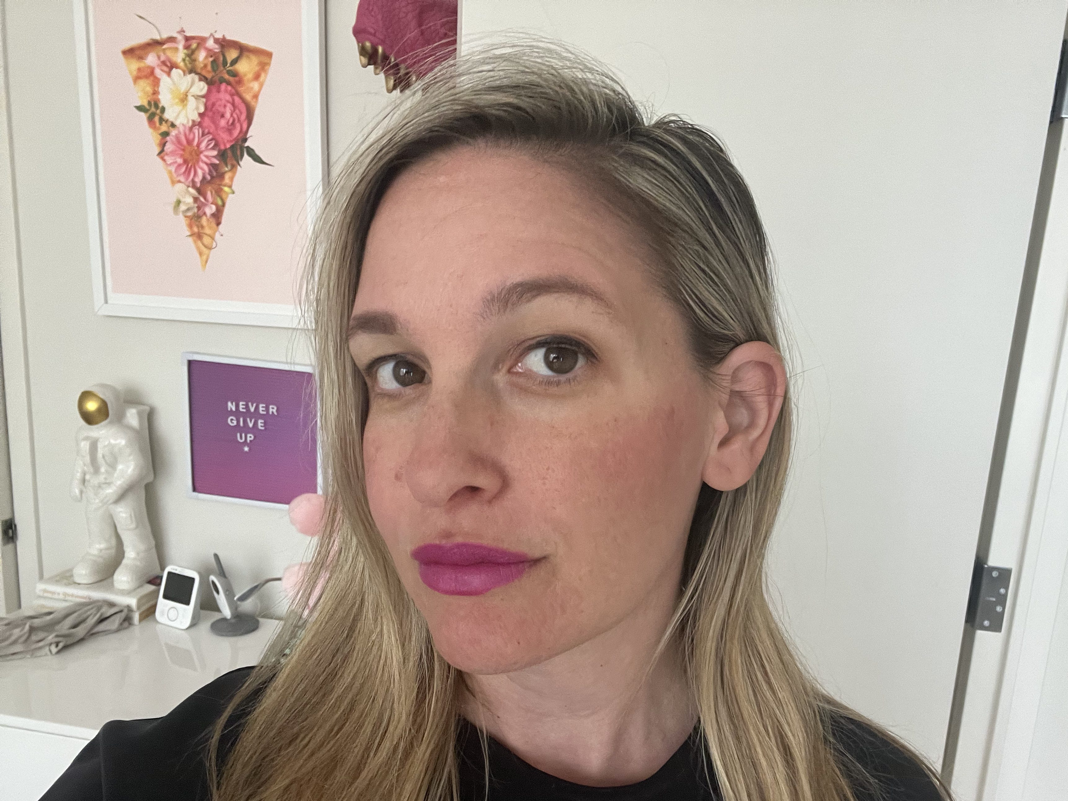 Author taking selfie with Supergoop sunscreen and makeup on.