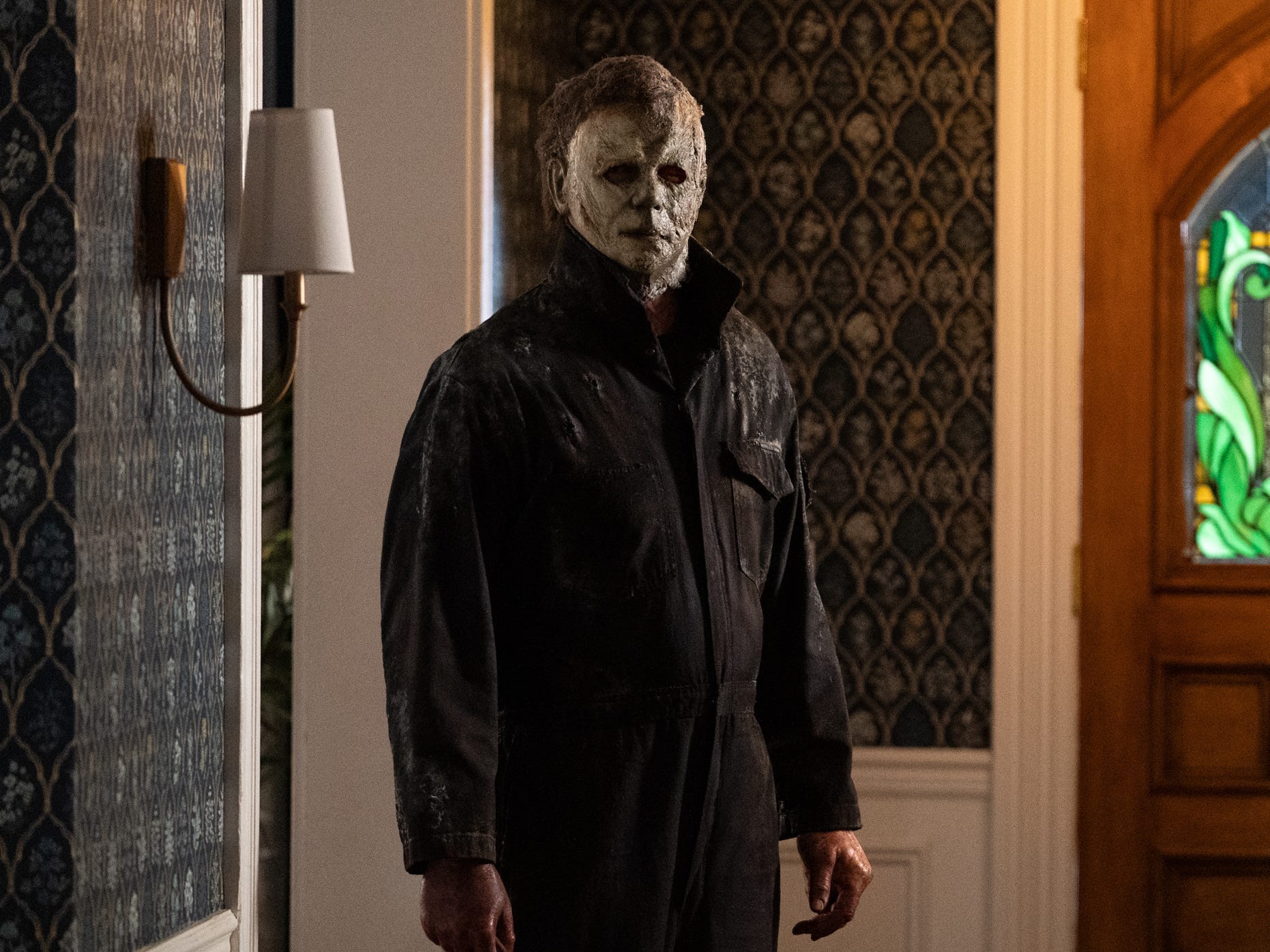Michael Myers standing in the entrance of a home with a knife in "Halloween Ends."