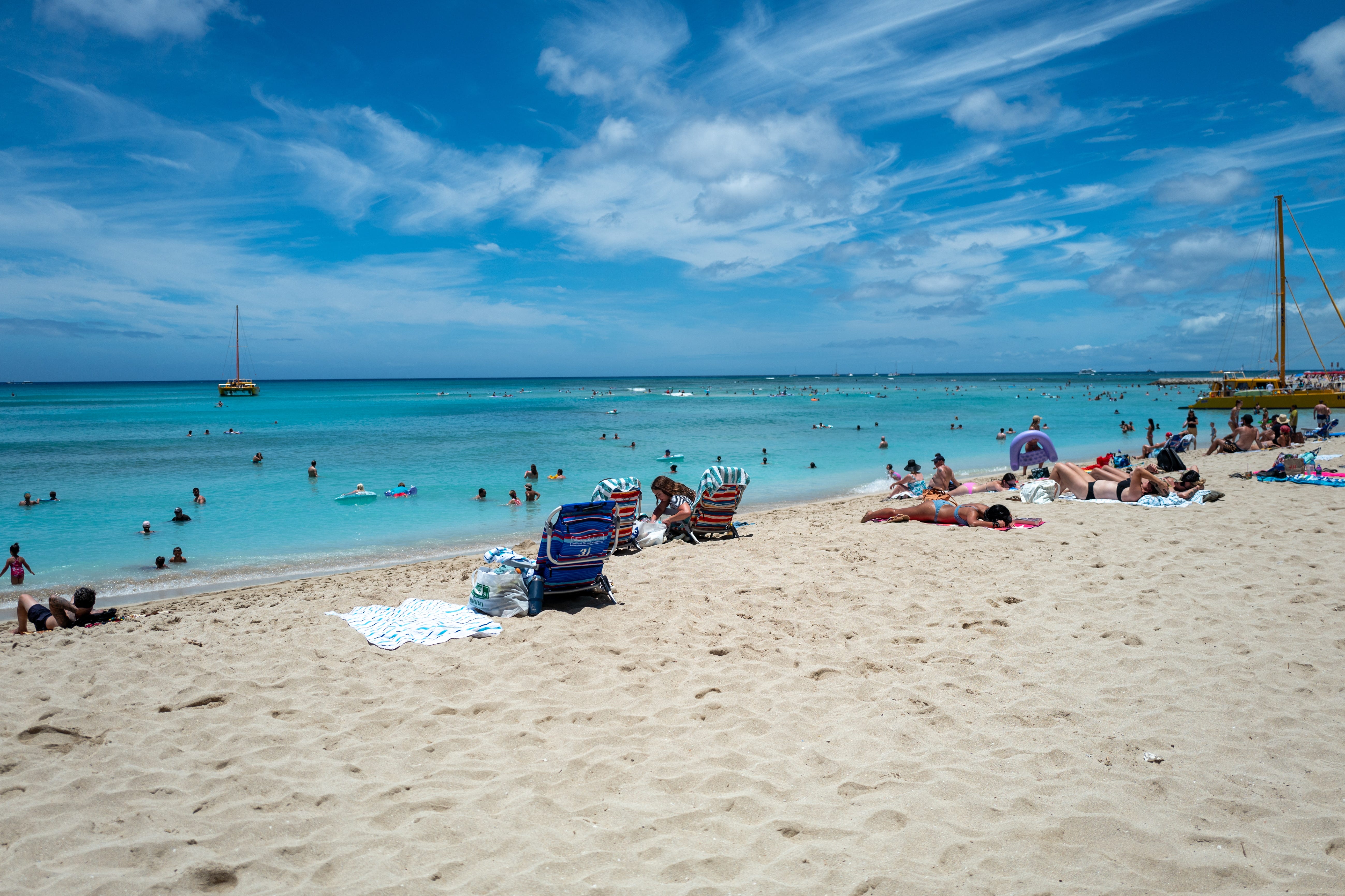 People relaxing on Waikiki Beach in Oahu.