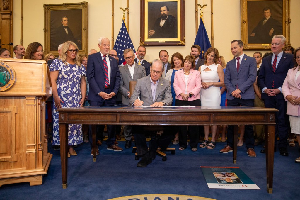 Indiana Governor Mike Braun signing educational legislation.