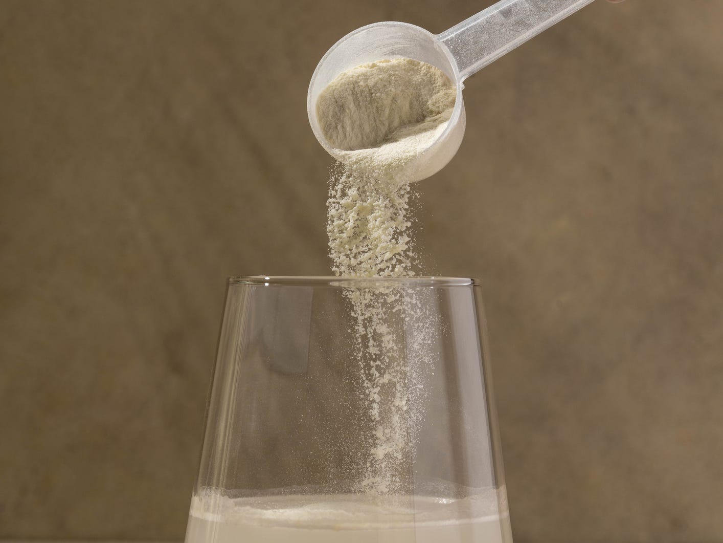 A person pouring fiber into water