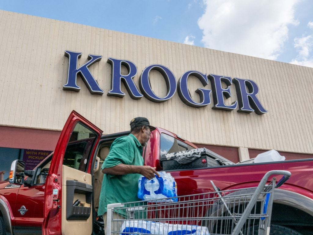 A customer loading his truck after shopping at a Kroger grocery store.