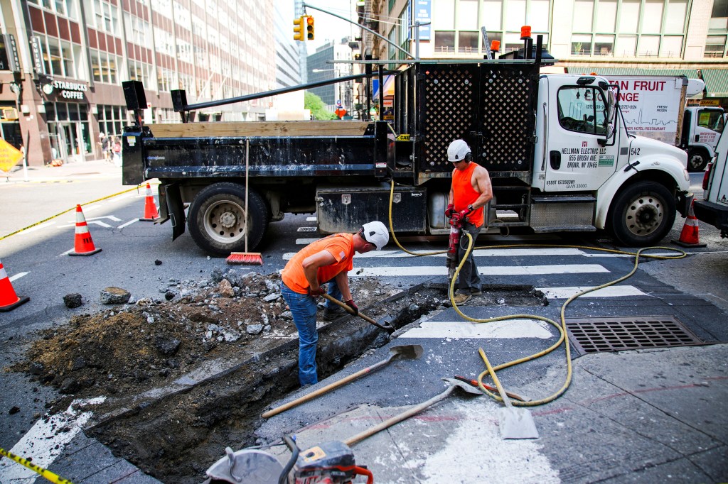 Construction workers repairing a street in New York City.