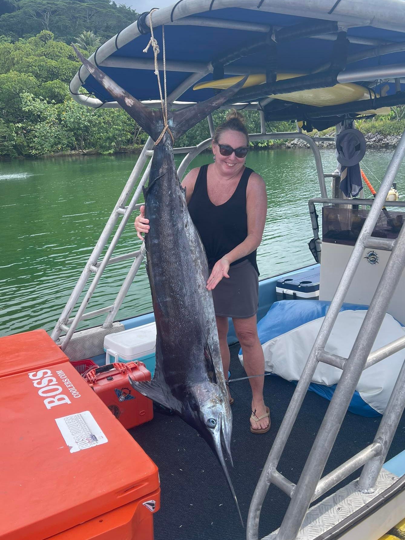A woman posing with a fish.