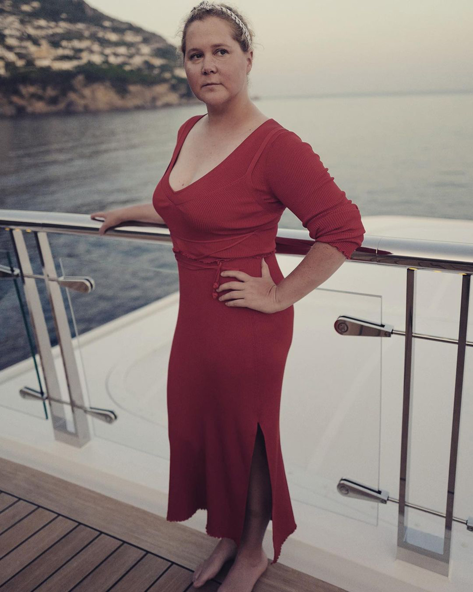 Amy Schumer in a red dress on a boat. 