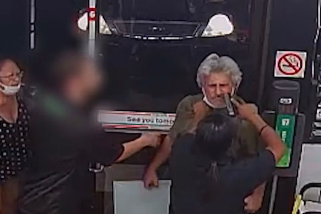Mitchell holds a gun up to Martin's face during the altercation inside the store.