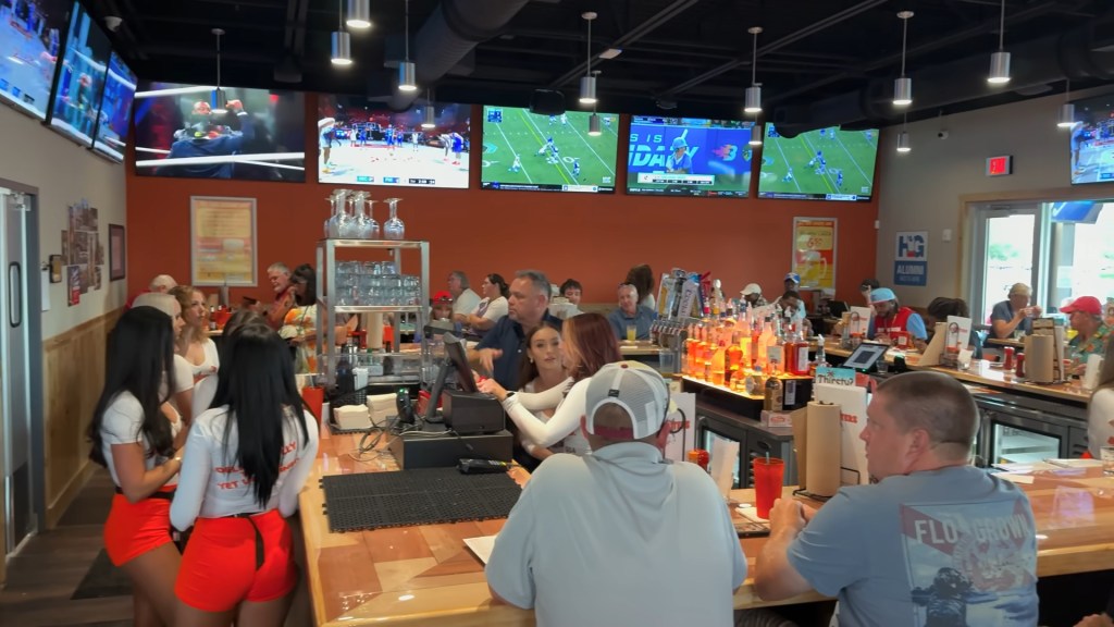 Customers filled the tables as servers work inside The Hooters in The Villages, Florida on July 7, 2025.