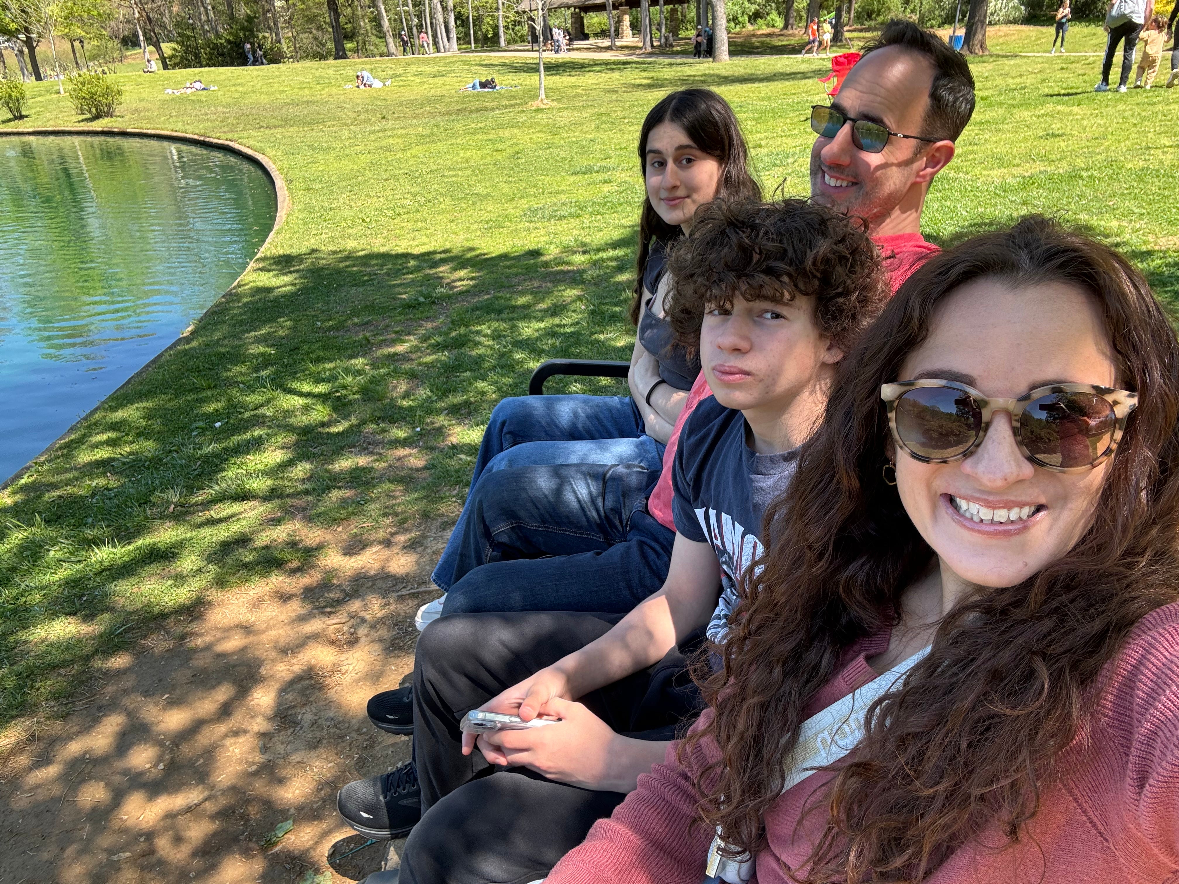 Valerie Mantelli with her husband and two kids in a park