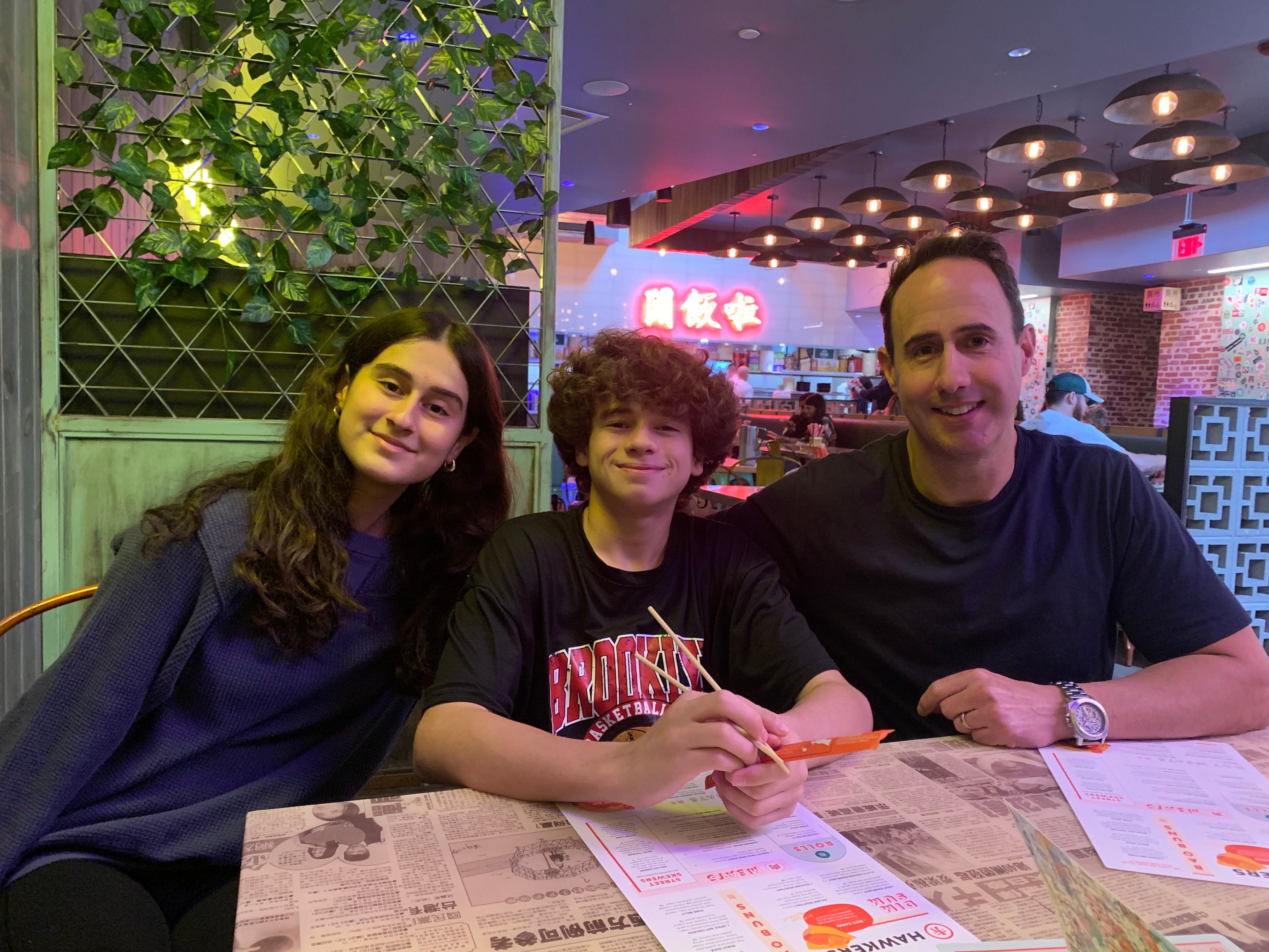 Valerie Mantelli's husband and two kids at a restaurant