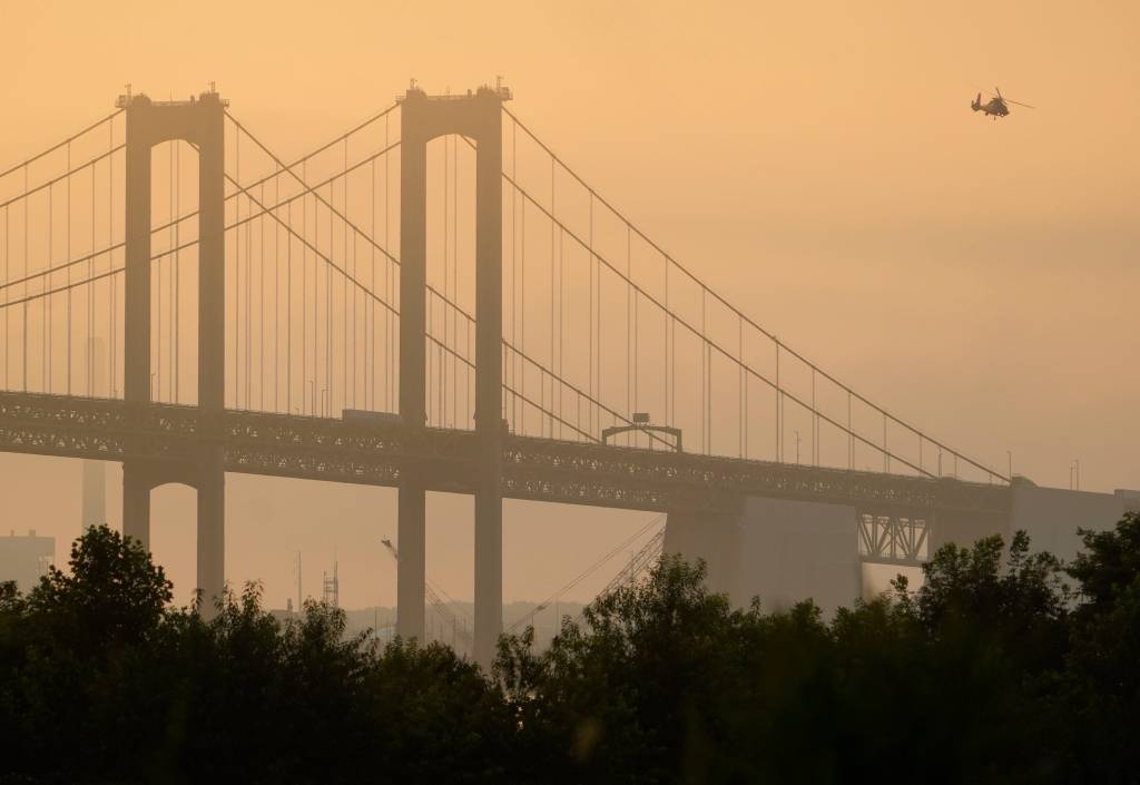 Helicopter over Delaware Memorial Bridge in hazy conditions.