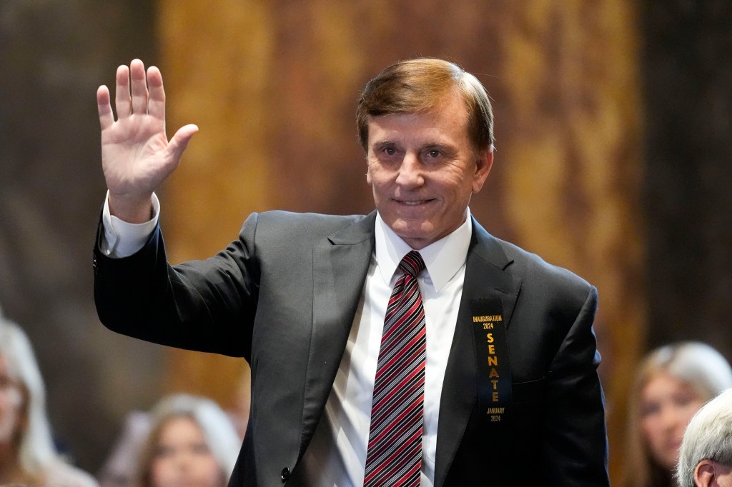 John Fleming waving at his swearing in.