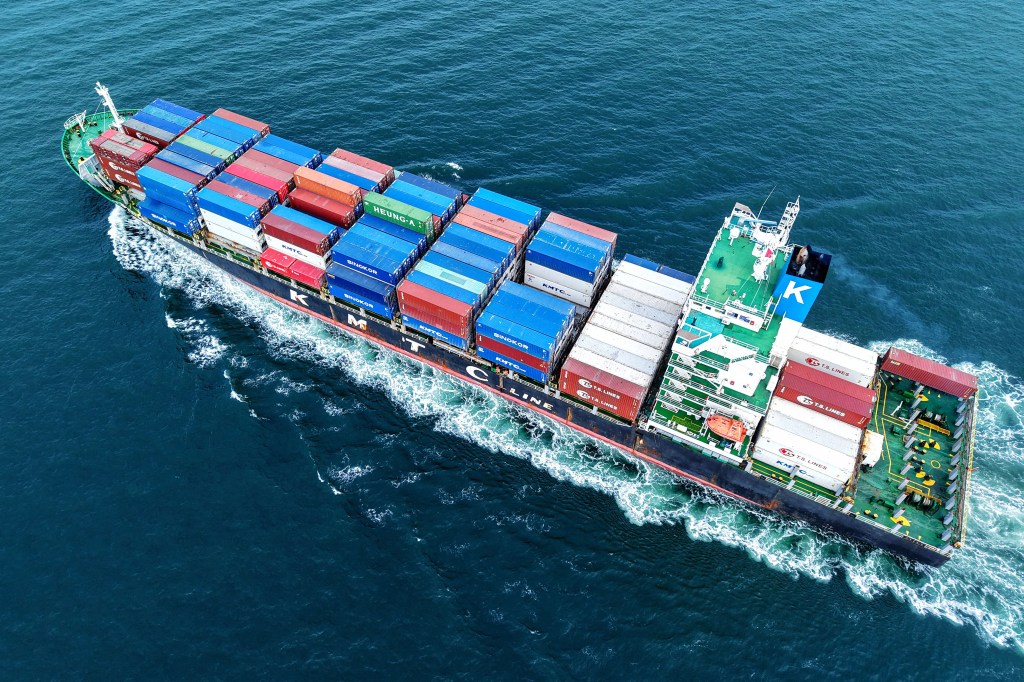 Aerial view of a cargo ship at sea.