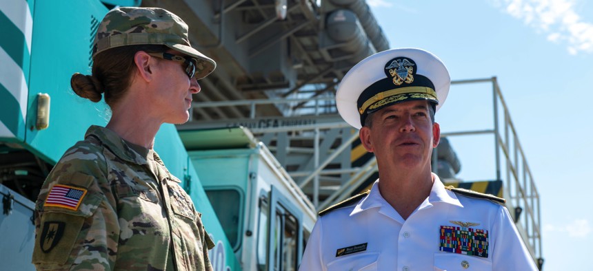 Rear Adm. Buzz Donnelly, right, Commander, Carrier Strike Group (CSG) 5, speaks with Army Col. Alison Batig, director, Brian D. Allgood Army Community Hospital, after the USS Ronald Reagan (CVN 76) pulled in to Busan, Republic of Korea, on Sept. 23, 2022.