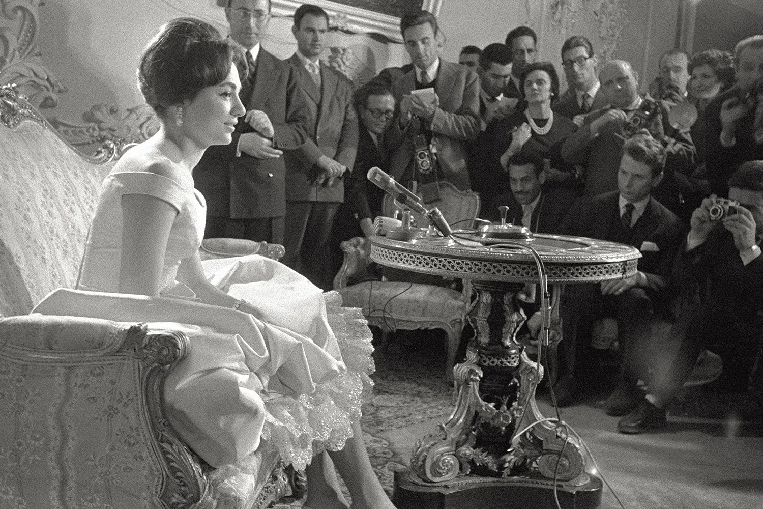 Empress Farah Pahlavi speaks with journalists after her wedding.