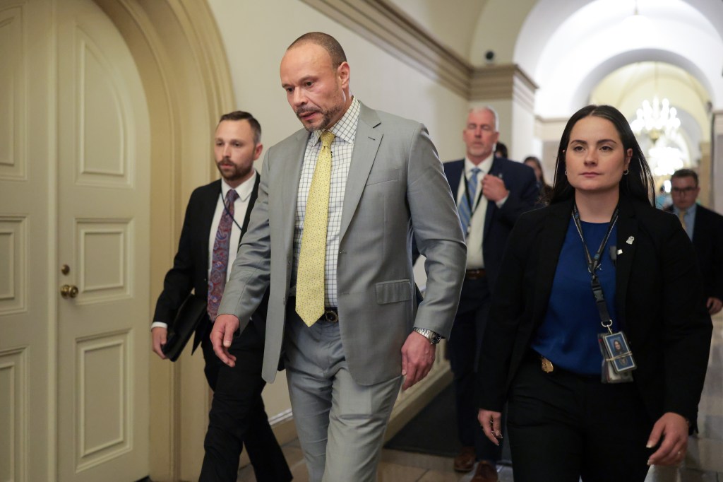Republican lawmakers walking in Capitol Hill hallway.