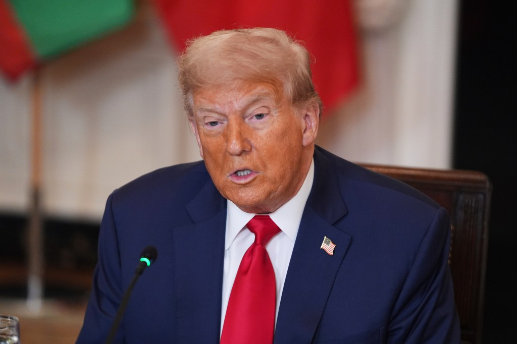Donald Trump speaking at a meeting.