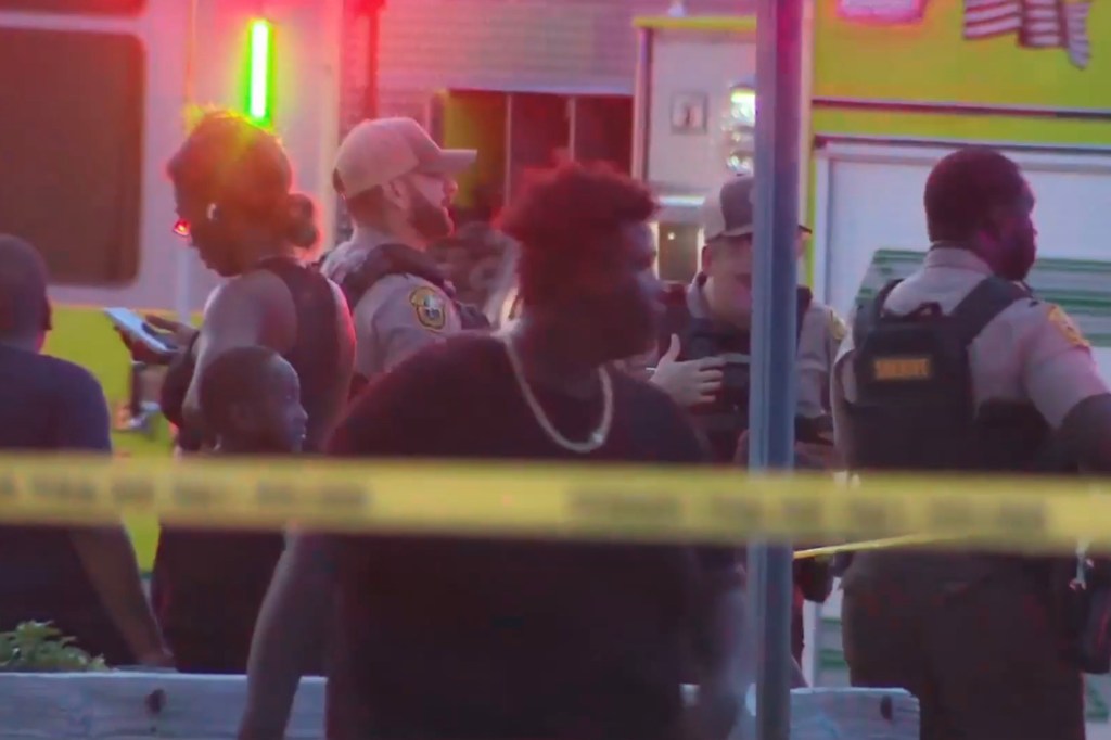 Police and bystanders stand around the park after the alleged rape on July 8, 2025.