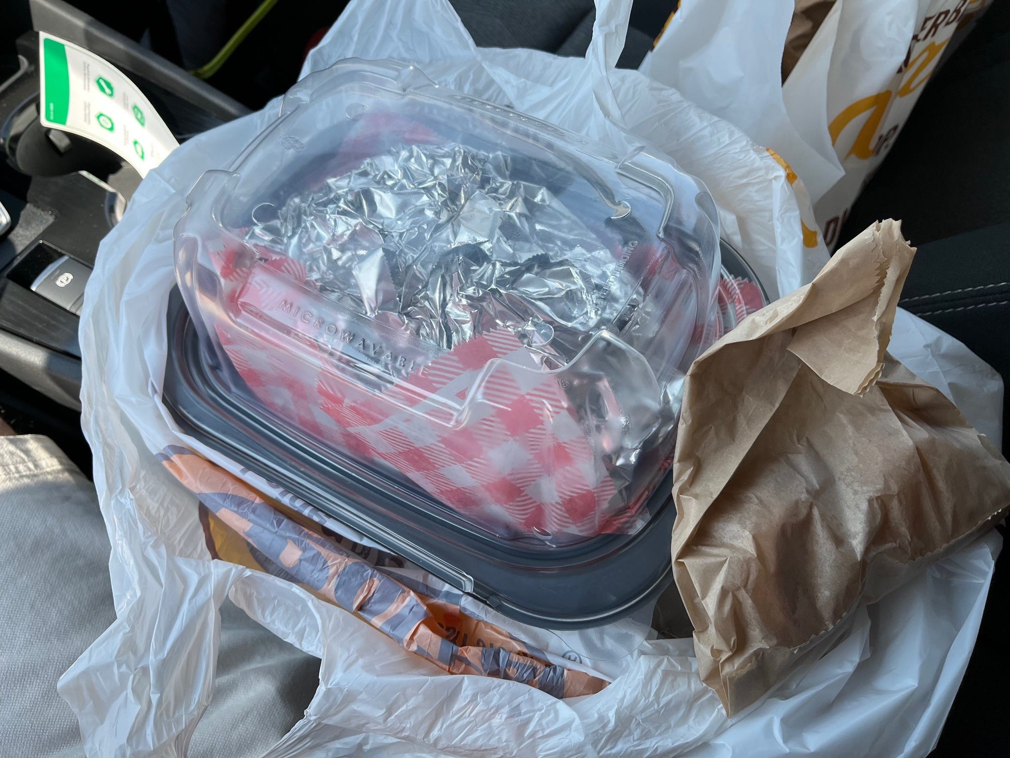 A campfire meal from Cracker Barrel wrapped up in aluminum foil and a plastic container