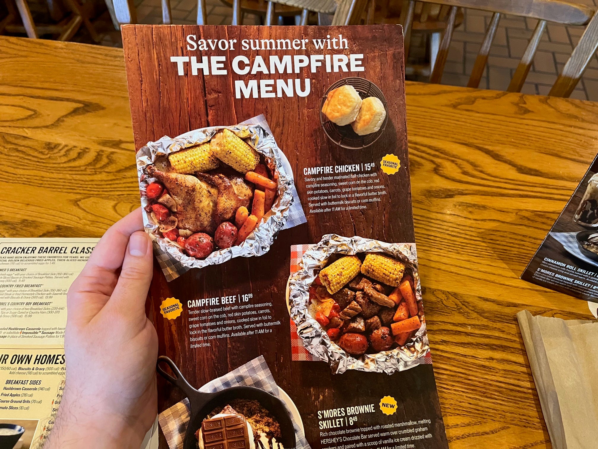 A menu insert at Cracker Barrel shows the chain's Campfire meals, including Campfire Chicken and Campfire beef, both of which are served in a foil-lined dish.