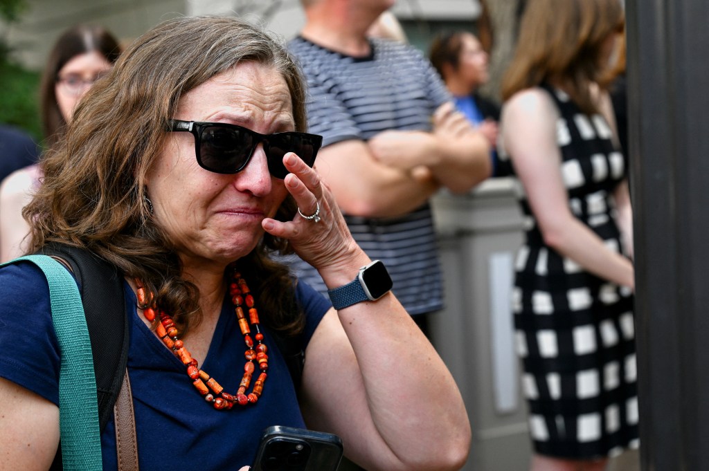 Woman crying at a sendoff event.
