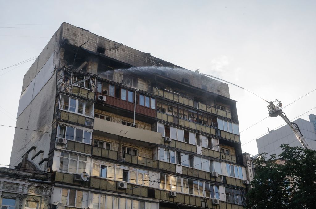 Firefighters extinguishing a fire in a damaged residential building in Kyiv, Ukraine.