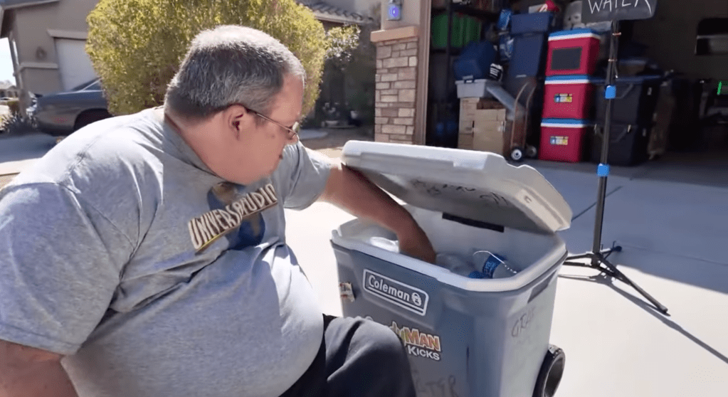 A neighbor grabs a water from Martin's cooler.