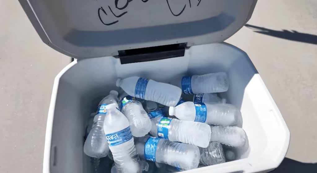 Frozen water bottles in a cooler.