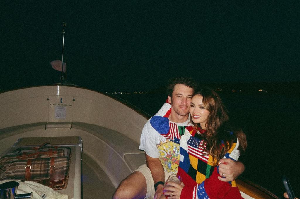 “Top Gun: Maverick” star Miles Teller and his wife, Keleigh, cozy up on a boat before watching some Fourth of July fireworks.