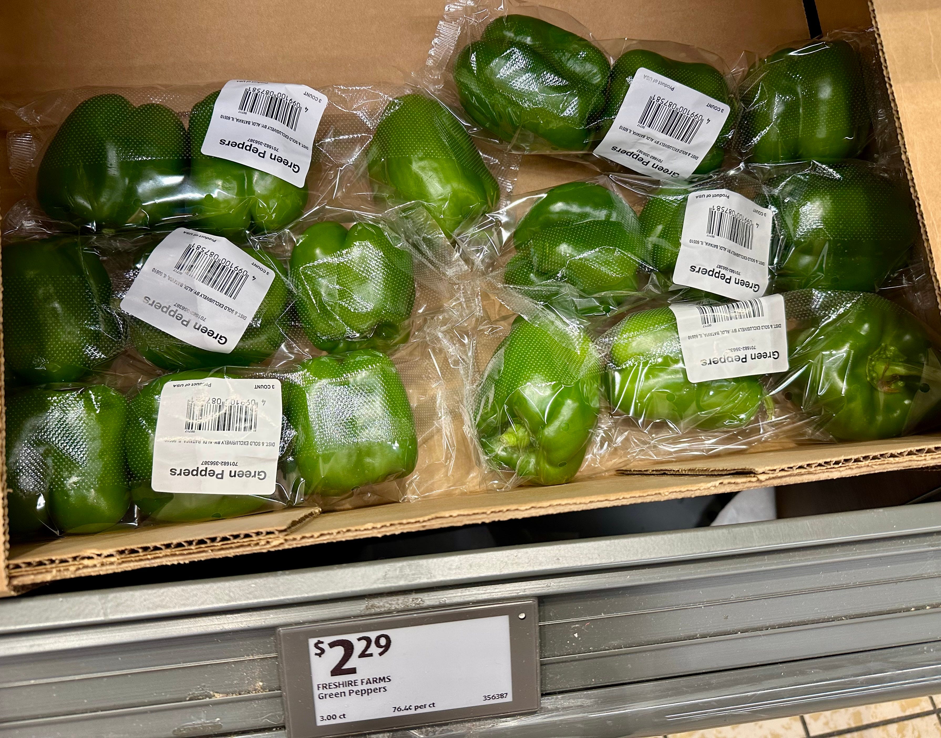 A box with packages of green peppers.