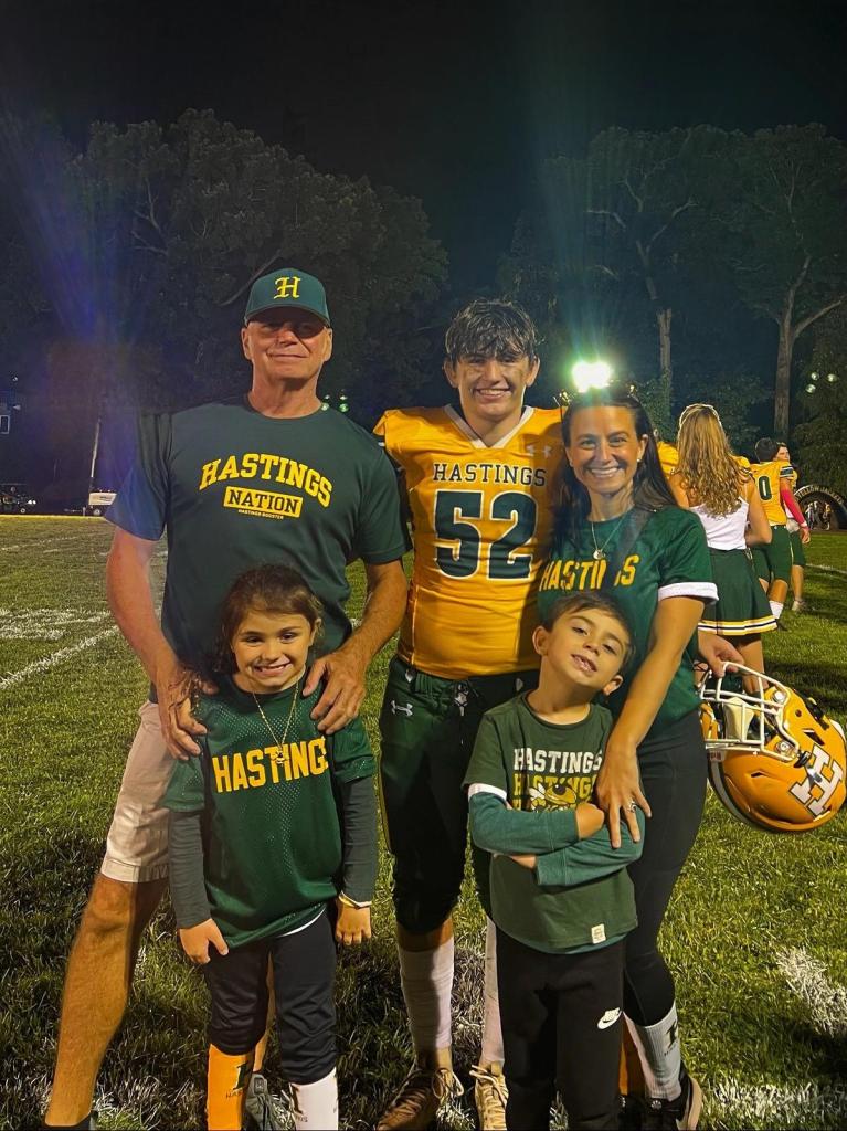 Rachel Napolitano-Curtis in a green football t-shirt, Aidan Curtis in yellow football jersey.