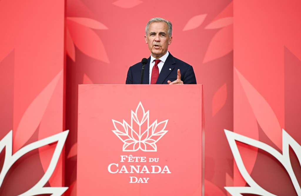 Mark Carney speaking at a Canada Day event.