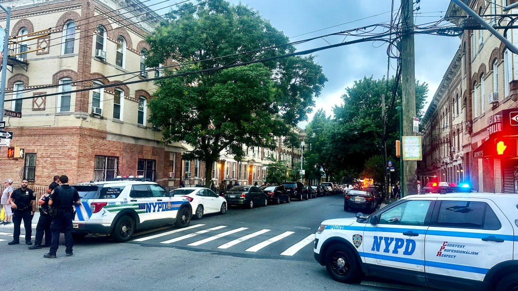 Police park at the corner of the block.