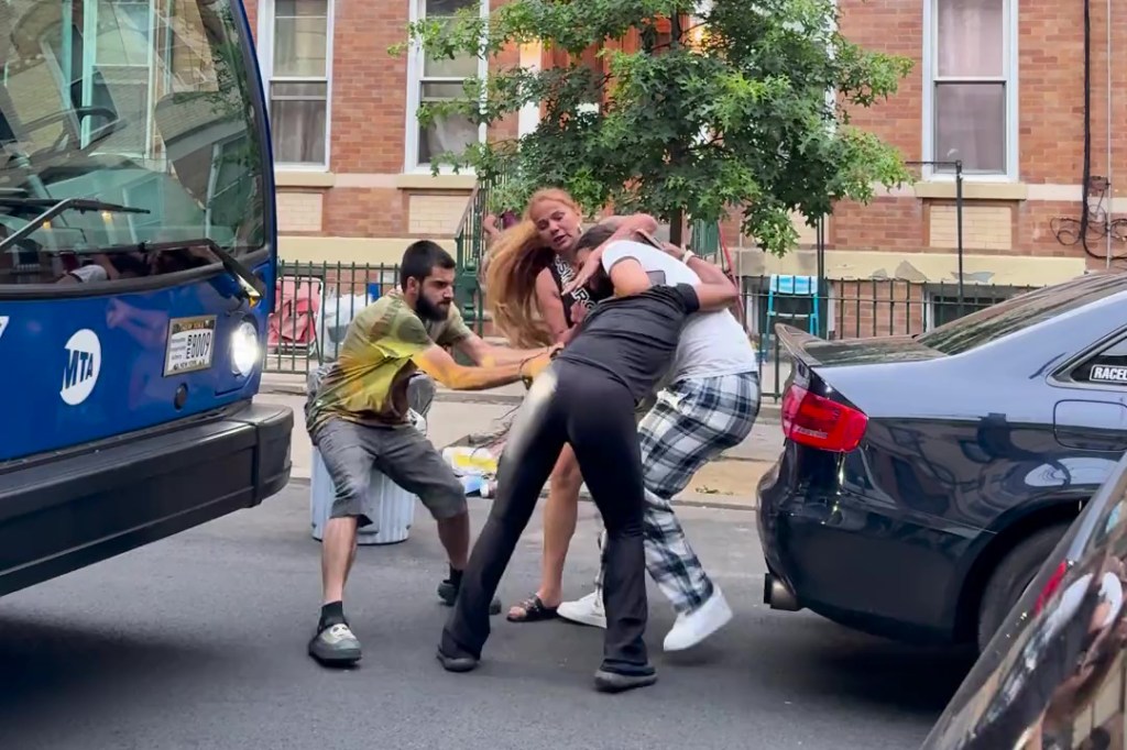 A screenshot of the mother and daughter, as well as a man, allegedly attacking McPherson. 
