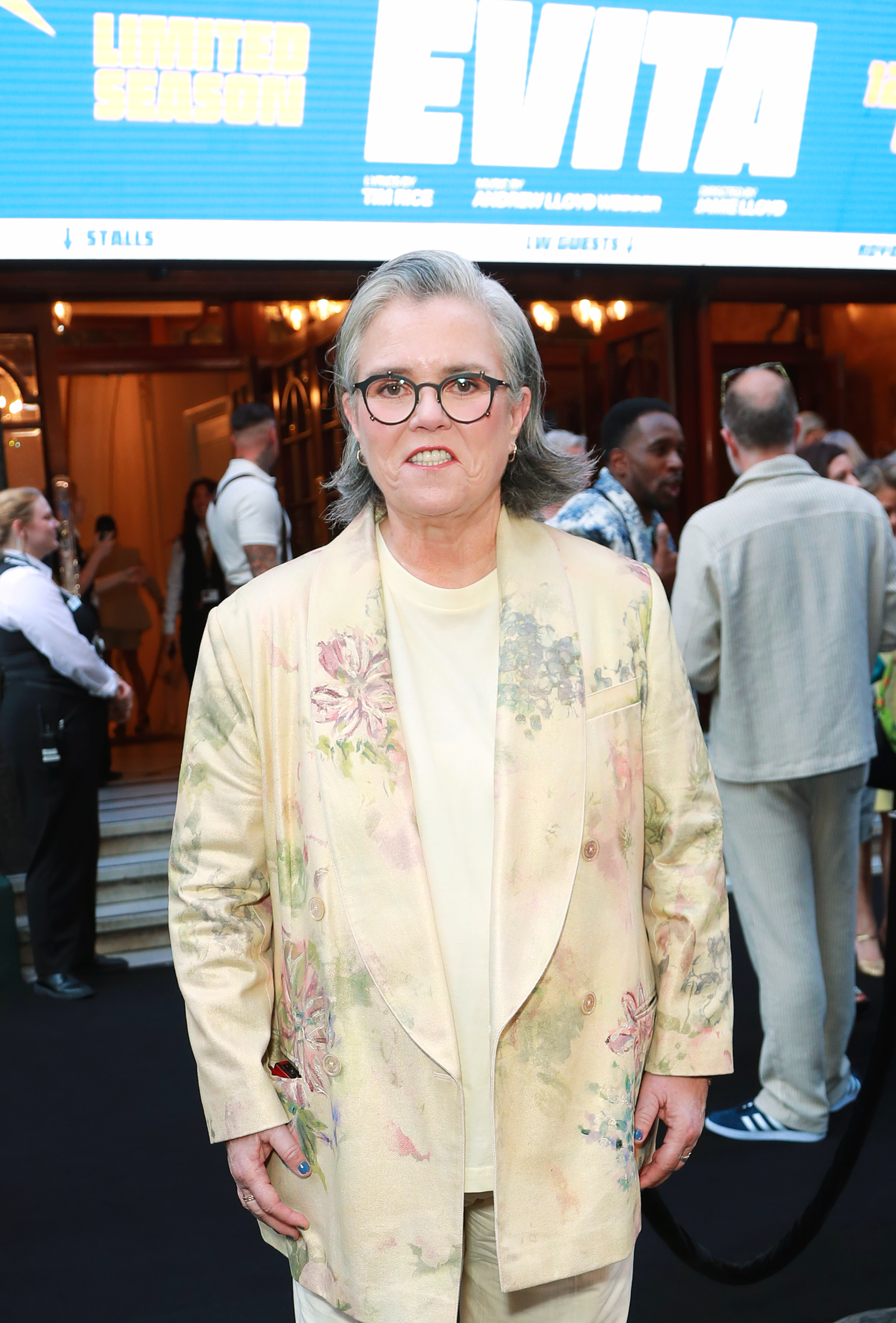 Rosie O'Donnell at an event wearing yellow. 