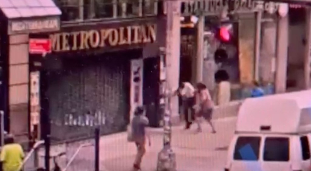 Screenshot of an off-duty NYPD detective fighting a man throwing food at her.