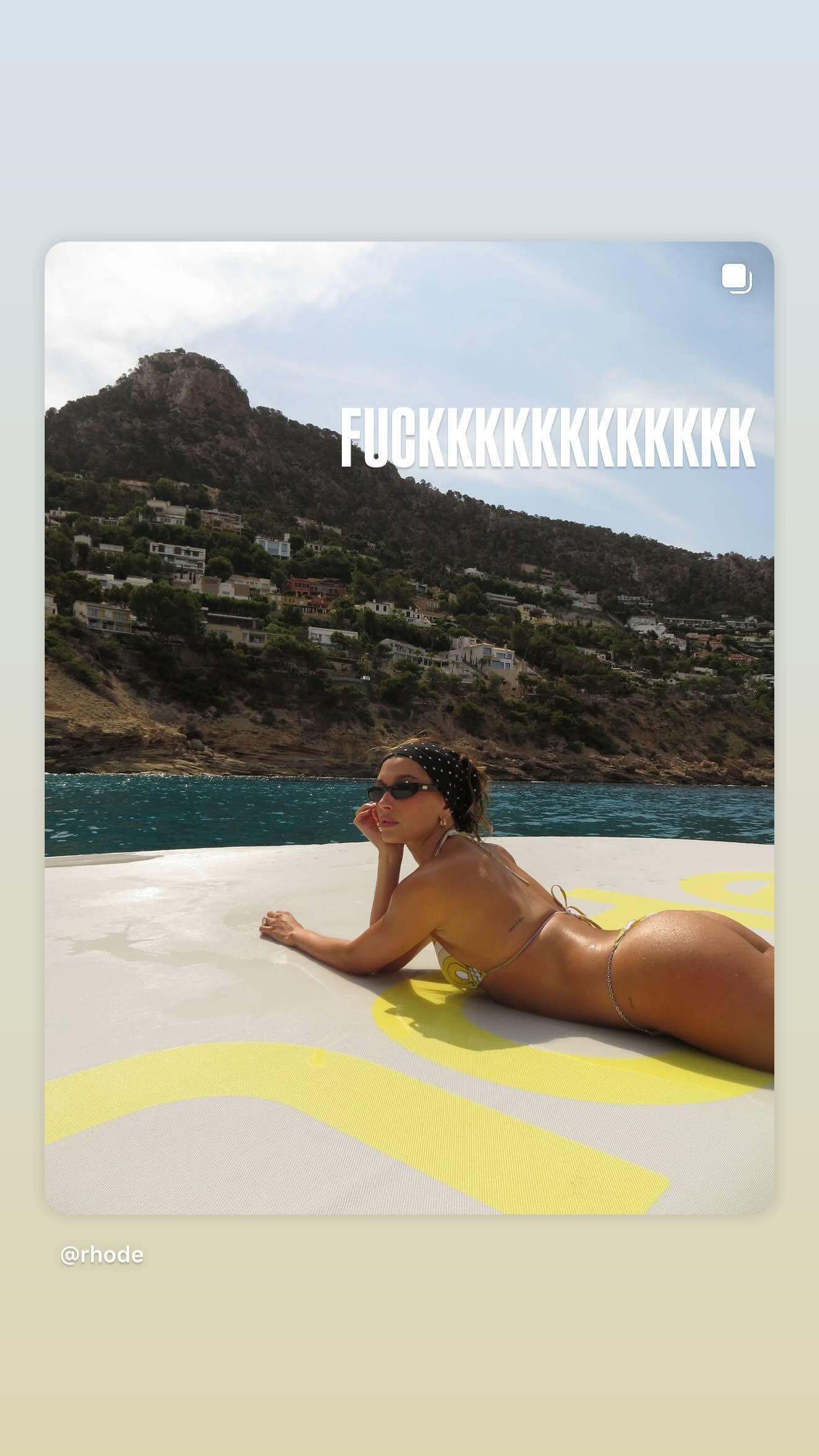 Hailey Bieber sunbathes in a thong bikini. 