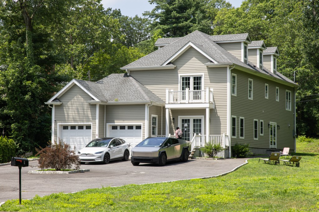 Exterior of home at 1 Kewanee Road in New Rochelle in daylight, with white Tesla and silver Cybertruck in driveway