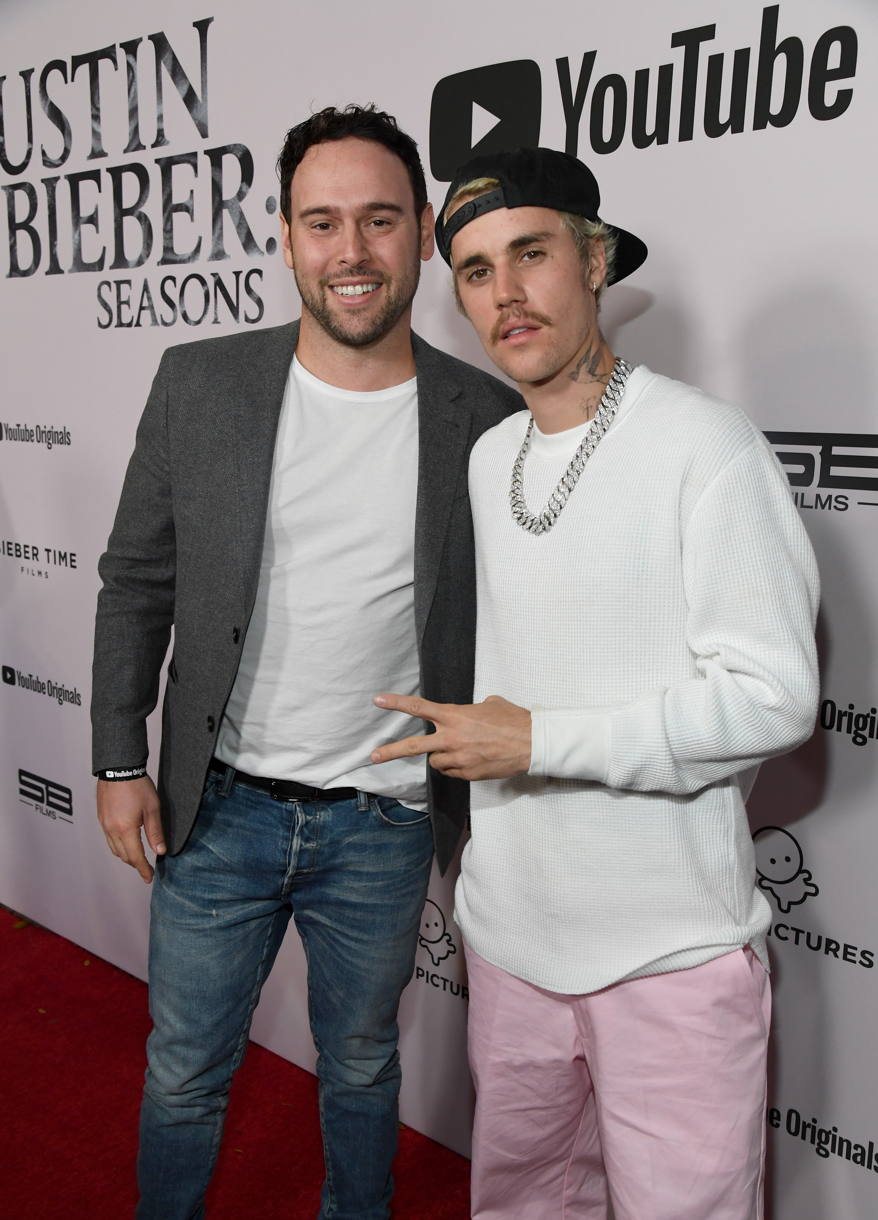 Justin Bieber poses with Scooter Braun at an event. 