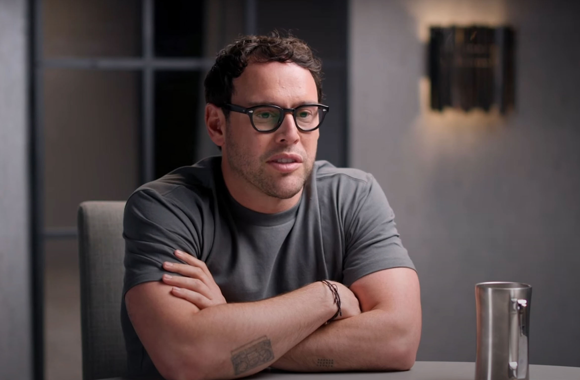 Scooter Braun folds his arms in an informal photo. 