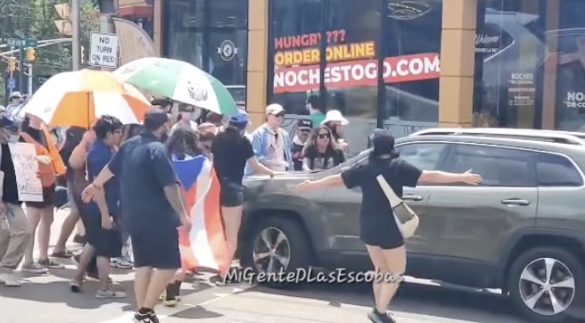 Protestors confronting a driver who hit people in Fairview, NJ.