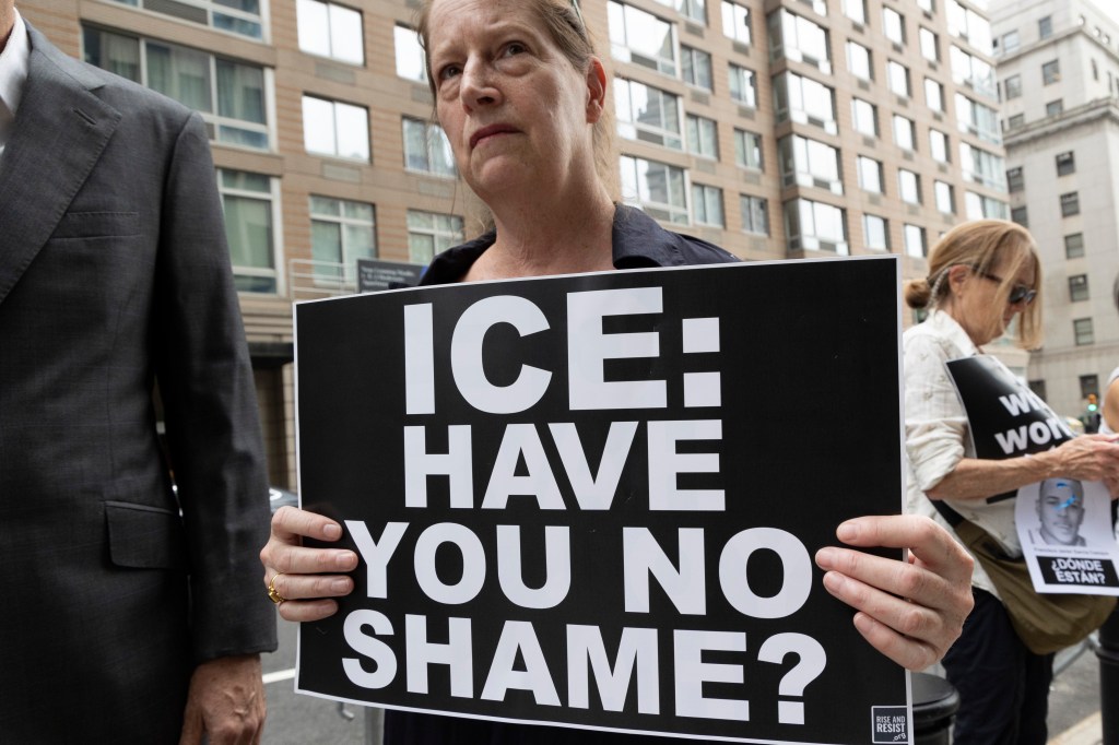 A woman holding a sign at an anti-ICE protest outside of 26 Federal Plaza in Manhattan on July 10, 2025.