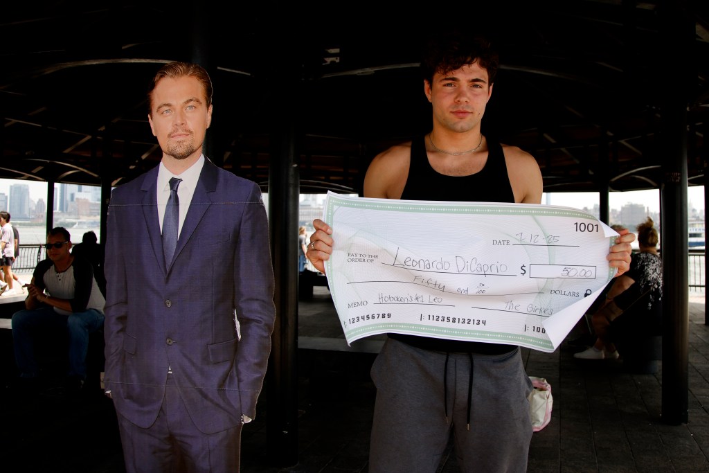 Nick Fine of Hoboken who won the Leonardo DiCaprio lookalike contest holds his $50 check winnings