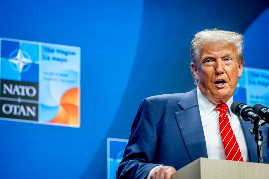 Donald Trump speaking at a NATO summit press conference.